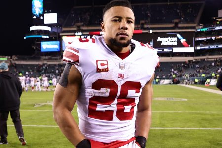 Saquon Barkley walks off the field after losing in the playoffs.