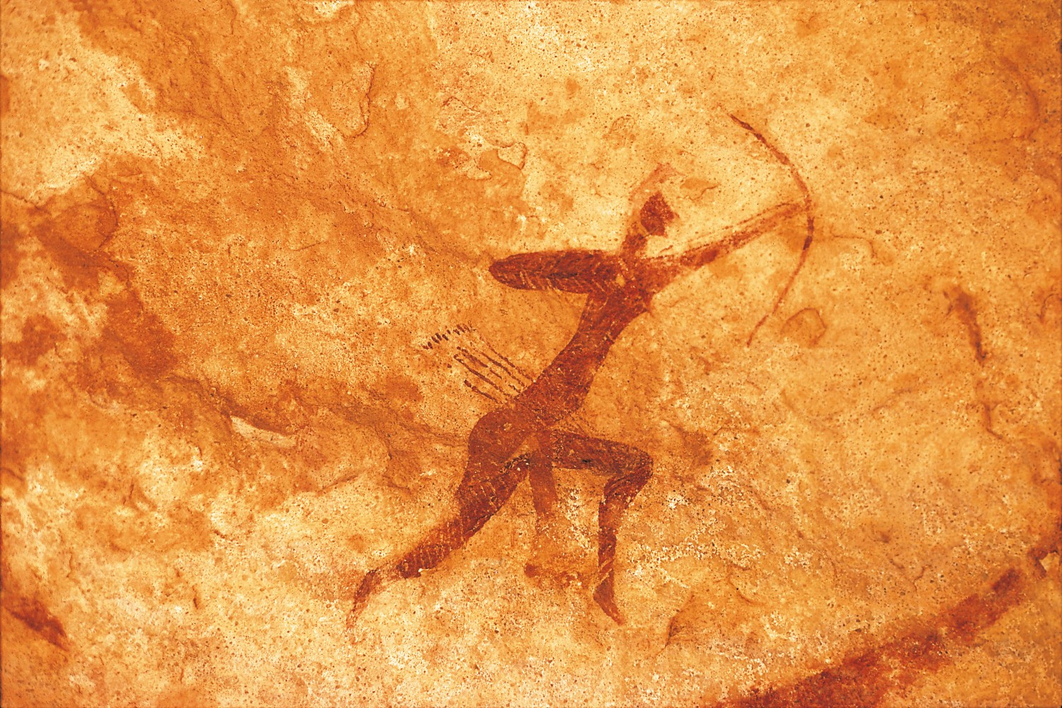 carving of figure with bow and arrows