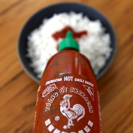 A bottle of Huy Fong Foods sriracha sauce.