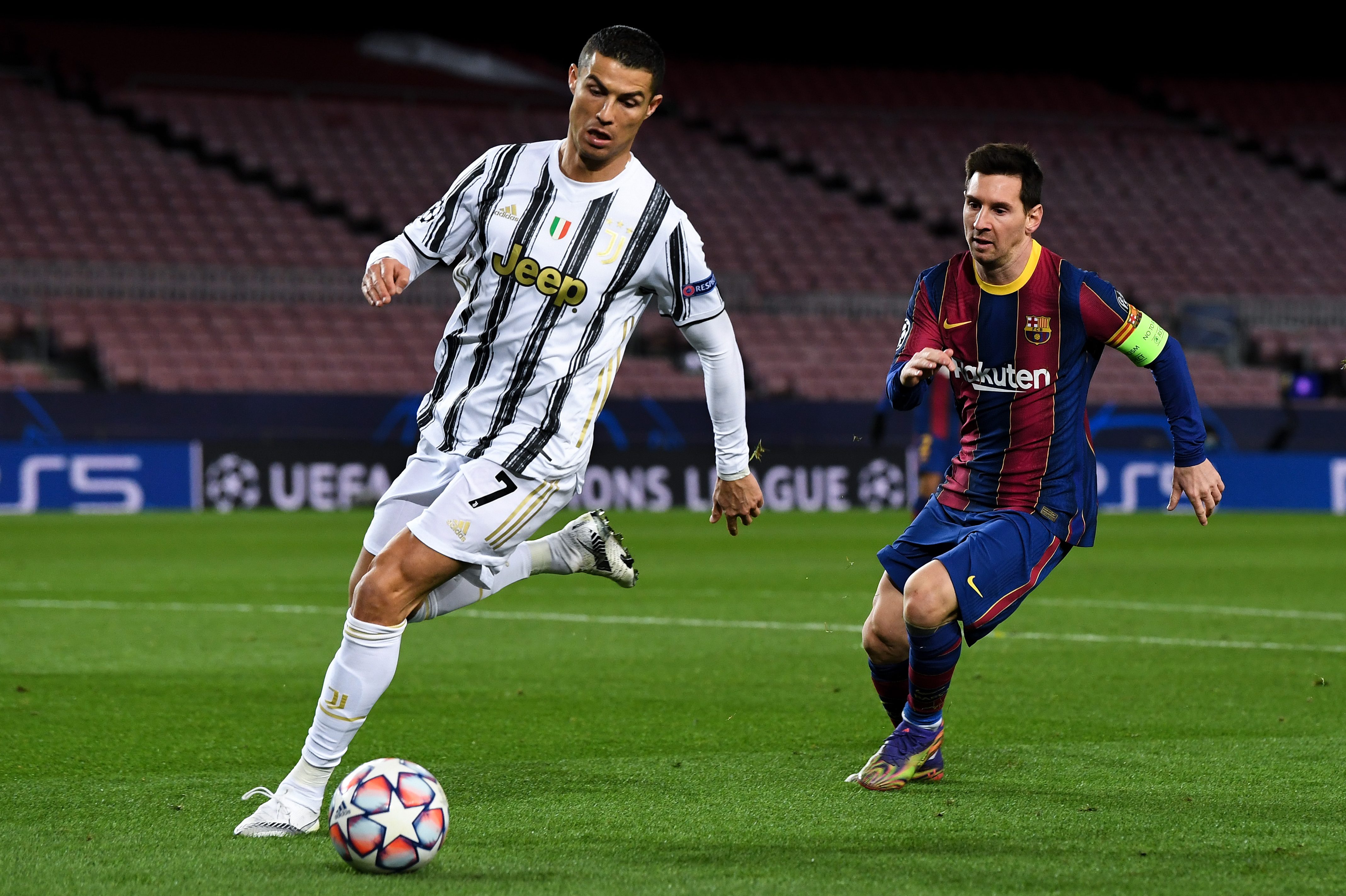Cristiano Ronaldo is put under pressure by Lionel Messi in a Champions League match in 2020.