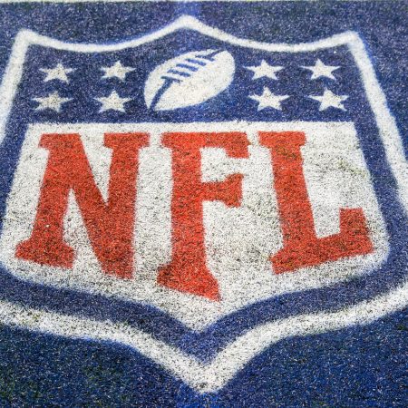 An NFL logo on the field.