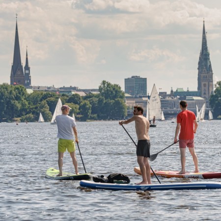 A trio of men on paddleboards in Germany.