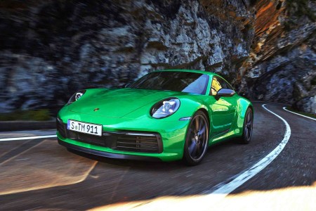 The 2023 Porsche 911 Carrera T in green driving up a mountain road
