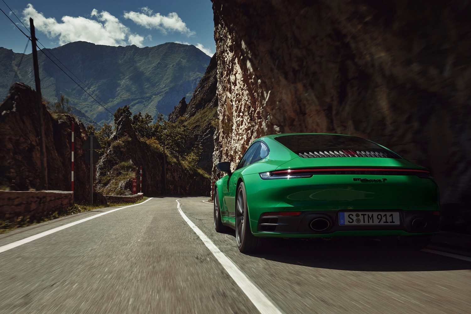 2023 Porsche 911 Carrera T rear end seen as it drives down the road