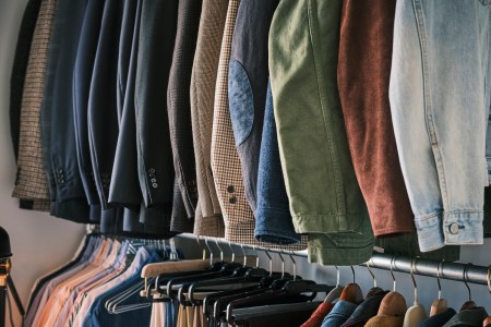 Shirts and pants hanging on clothing racks