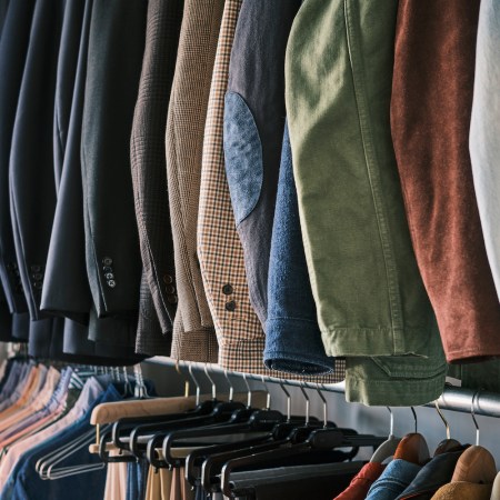 Shirts and pants hanging on clothing racks