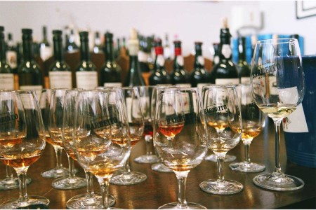 Several glasses and bottles of Barbeito's wine from Madeira