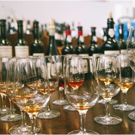 Several glasses and bottles of Barbeito's wine from Madeira
