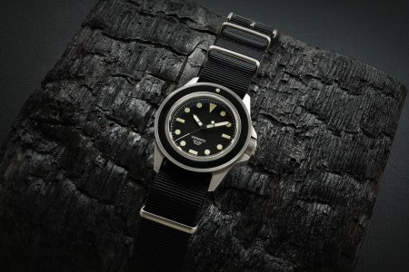 A Unimatic watch on a black background