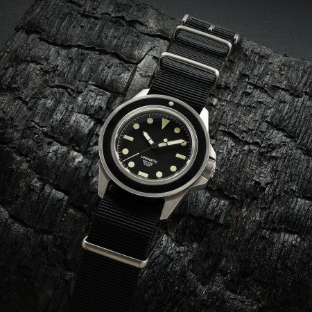 A Unimatic watch on a black background
