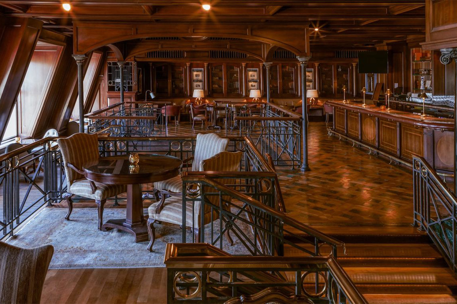 Tables, chairs and a bar in a brown-decorated room