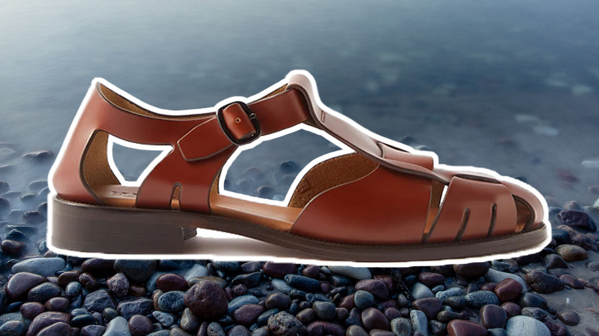 a tan fisherman sandal on a pebbled beach