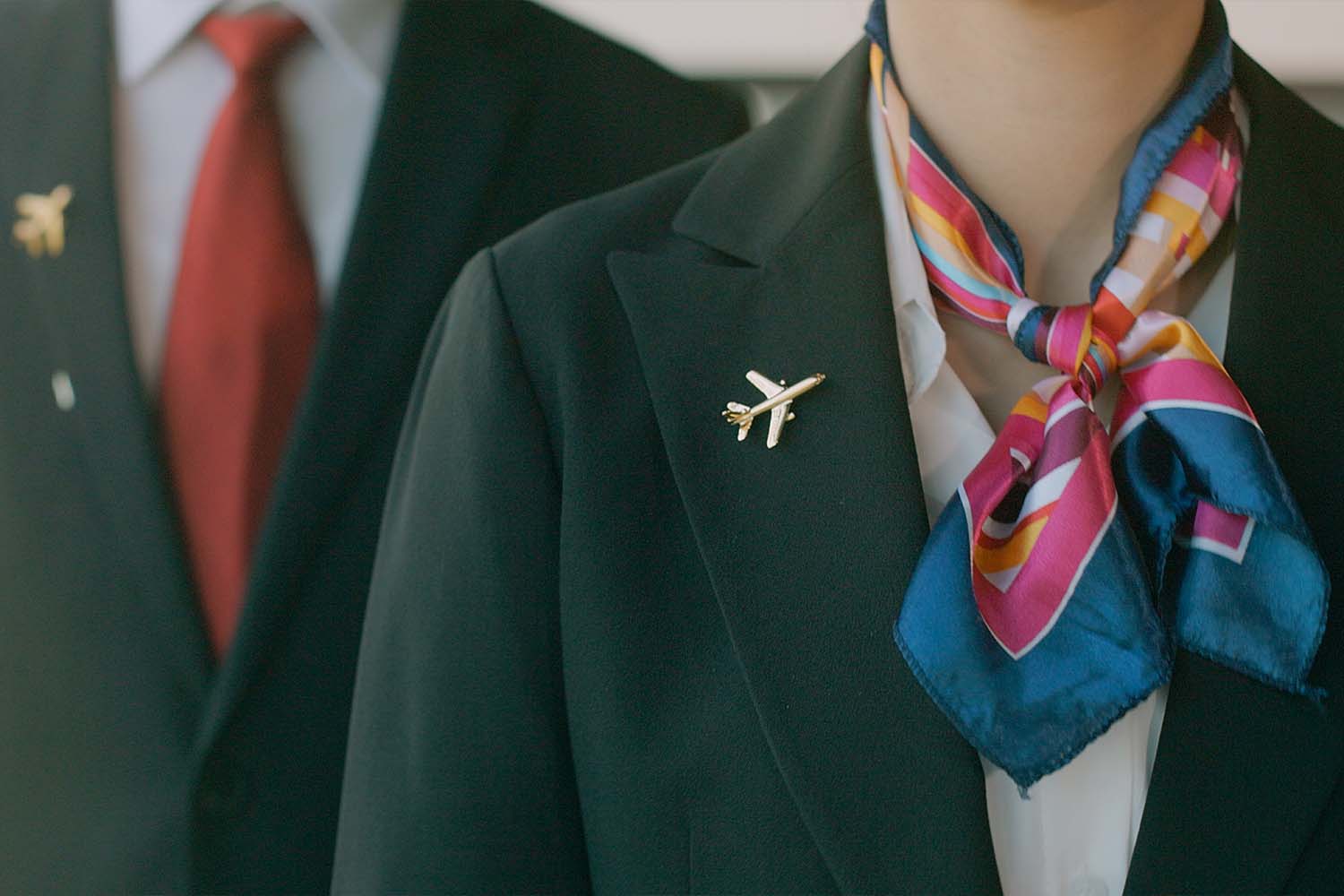 A picture from below the neck of two flight attendants, who may have funding soon for taking self-defense classes