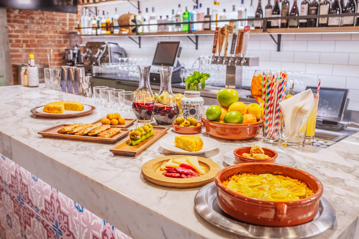 Spread of food and drinks on a bar counter