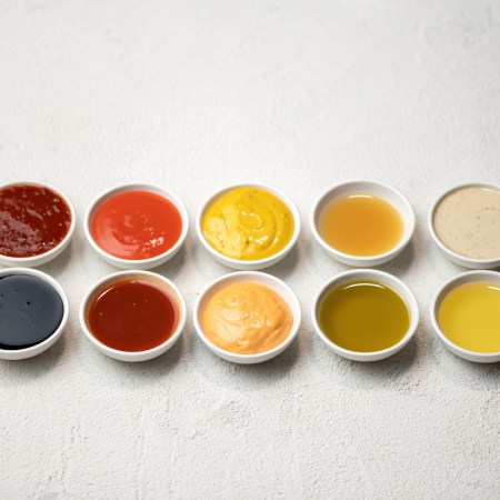 Big Set of colored sauces in Crockery. Different sauces, mayonnaise, mustard, soy sauce, oil and ketchup on white background.