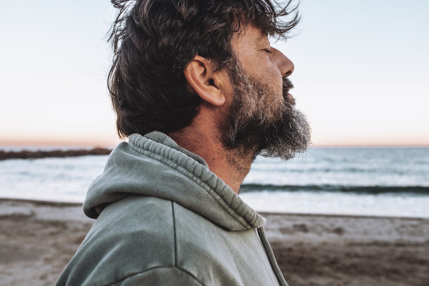 Mature man with eyes closed at beach