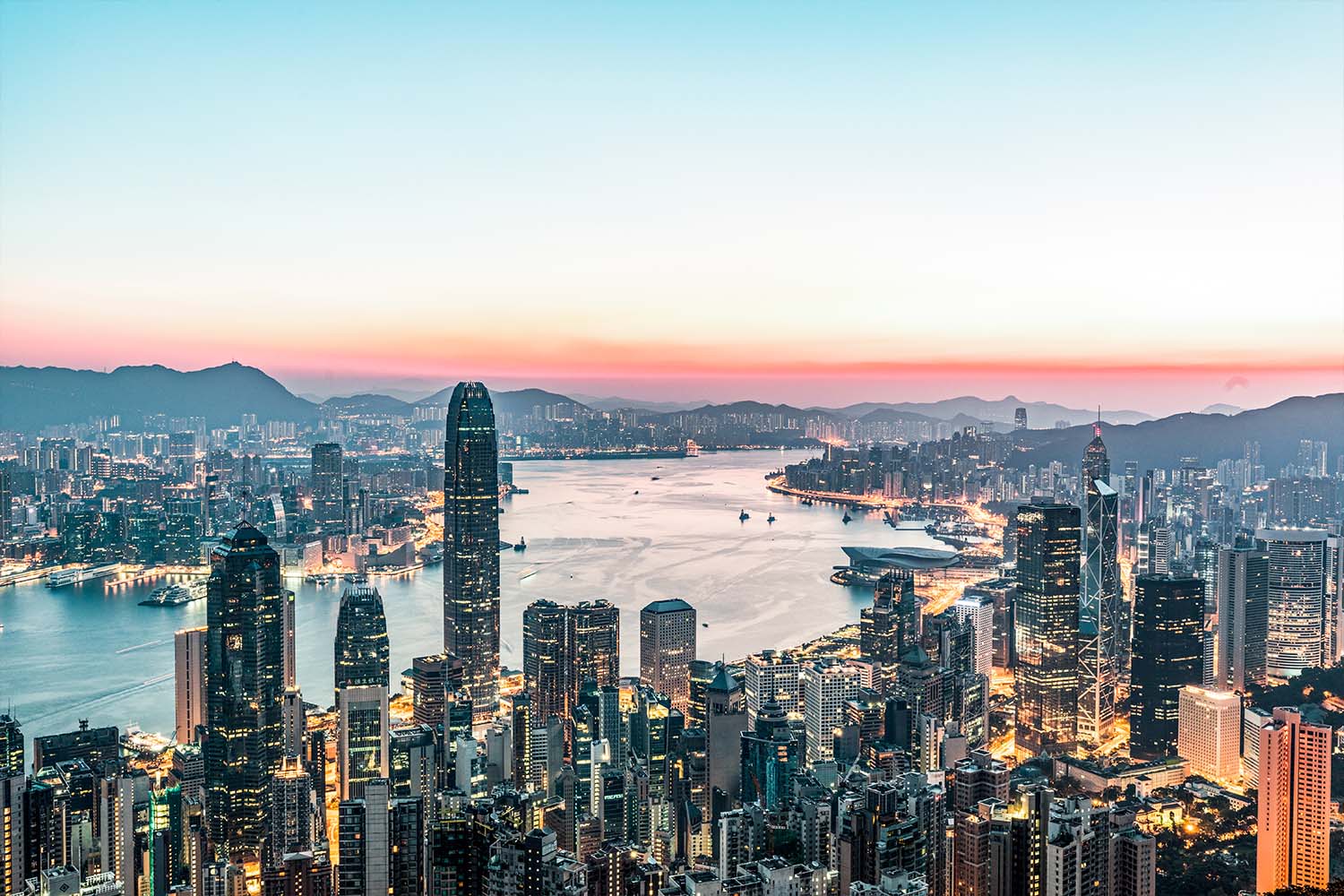The city of Hong Kong as seen from up high, overlooking the water, skyscrapers and hotels below