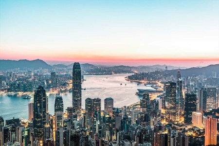 The city of Hong Kong as seen from up high, overlooking the water, skyscrapers and hotels below