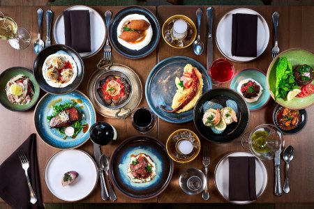 Spread of food with plates and drinks on a table