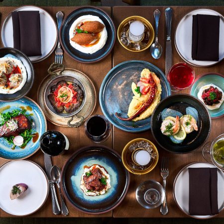 Spread of food with plates and drinks on a table