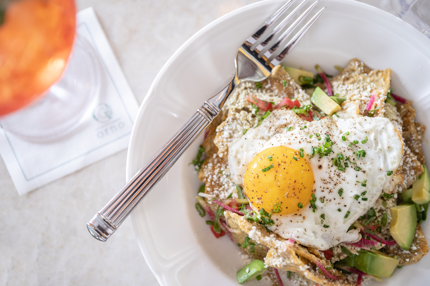 Egg with other toppings and sides in a bowl
