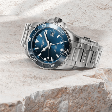 the Longines Hydroconquest GMT on a beige stone