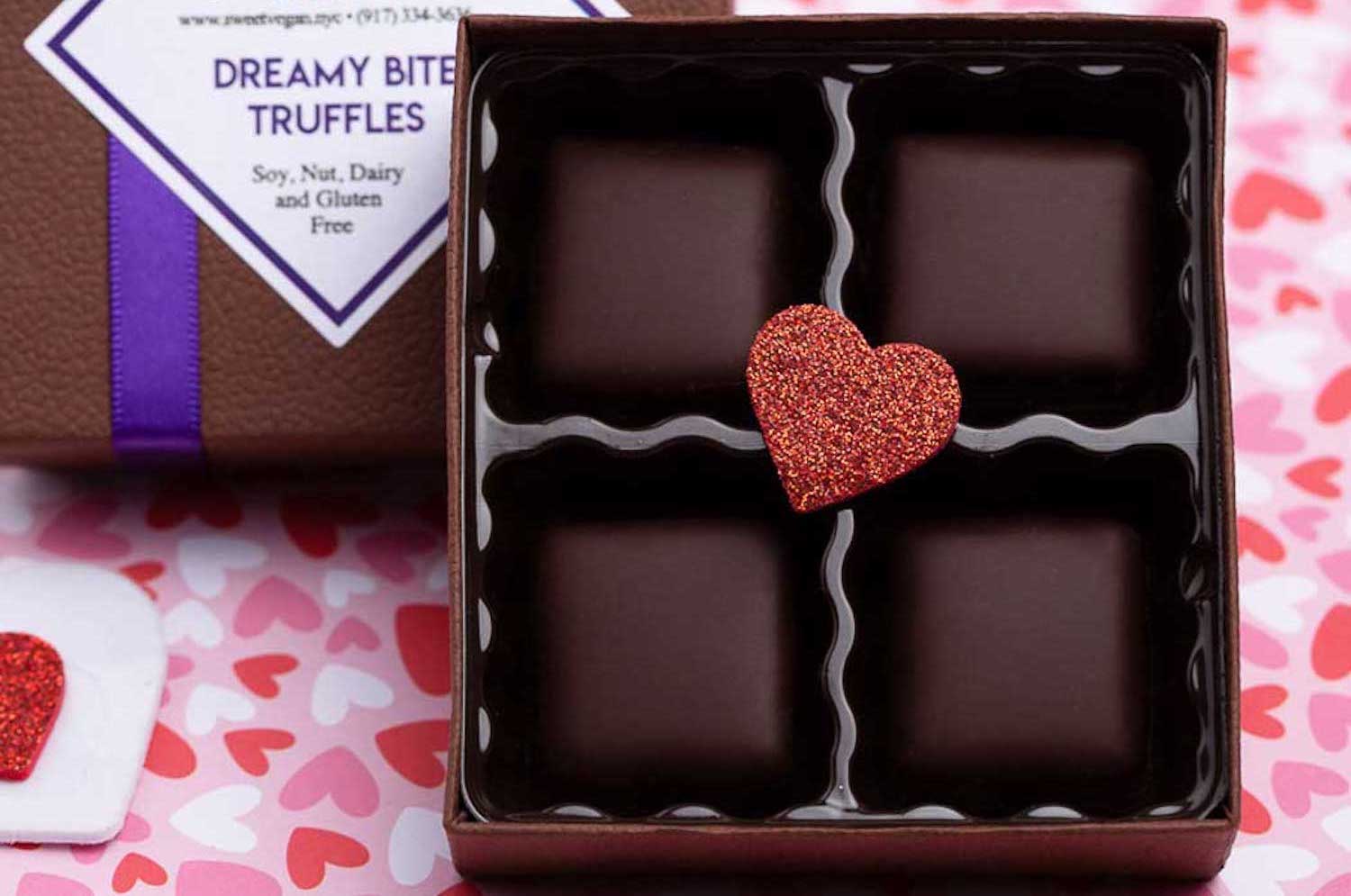 box of sweet vegan chocolate truffles with a red glitter heart in the middle