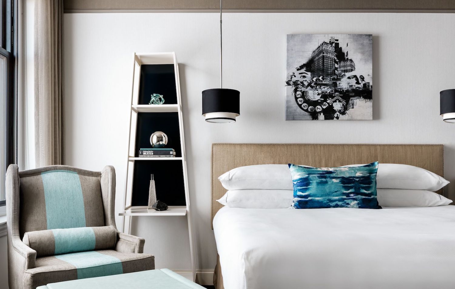White guest room with light-colored furniture and bedding