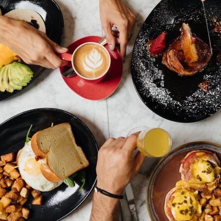 Spread of brunch foods on a table from a bird's-eye view