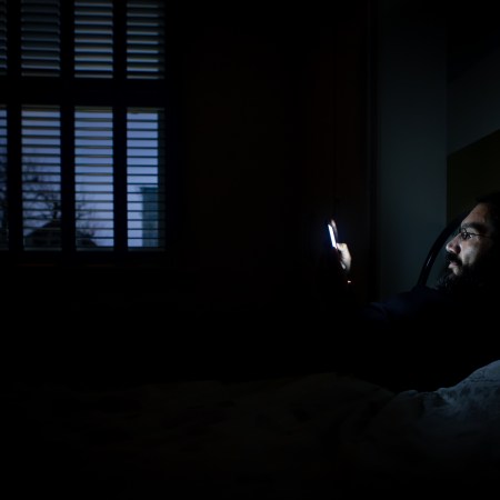 A man lying wake in bed.