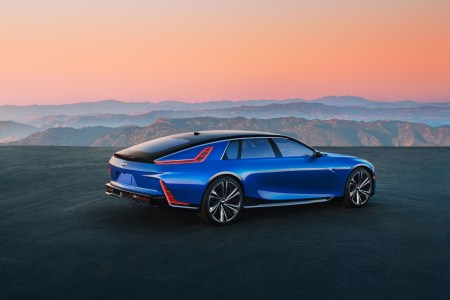 Rear 3/4 view of Cadillac CELESTIQ on a plateau overlooking mountains in the background.