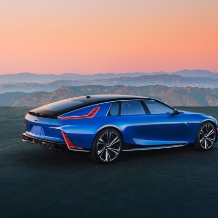 Rear 3/4 view of Cadillac CELESTIQ on a plateau overlooking mountains in the background.