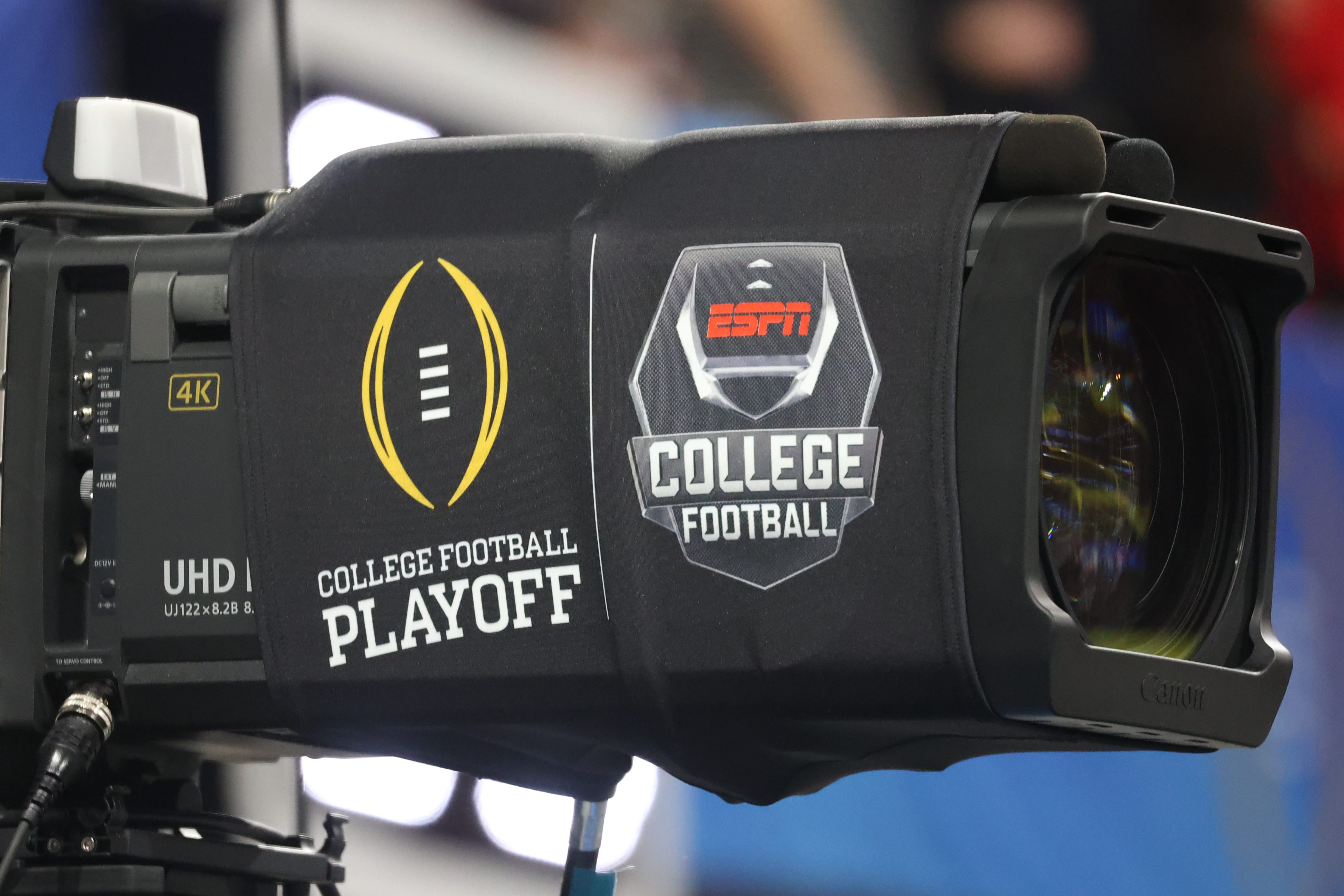 A TV camera with ESPN's college football playoff logos.