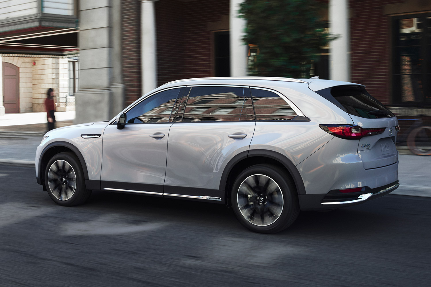The 2024 Mazda CX-90 SUV driving down the road