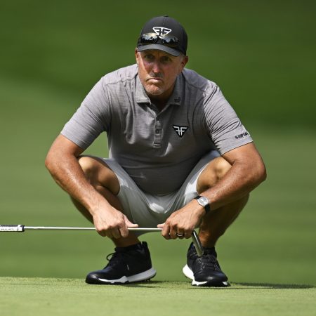 Phil Mickelson lines up a putt at the LIV Golf Invitational.