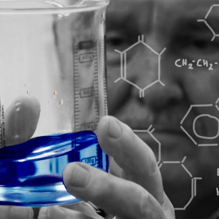 Professor David Nutt holding a beaker in a science lab. Nutt says he's created a non-alc drink that replicates the buzz of booze
