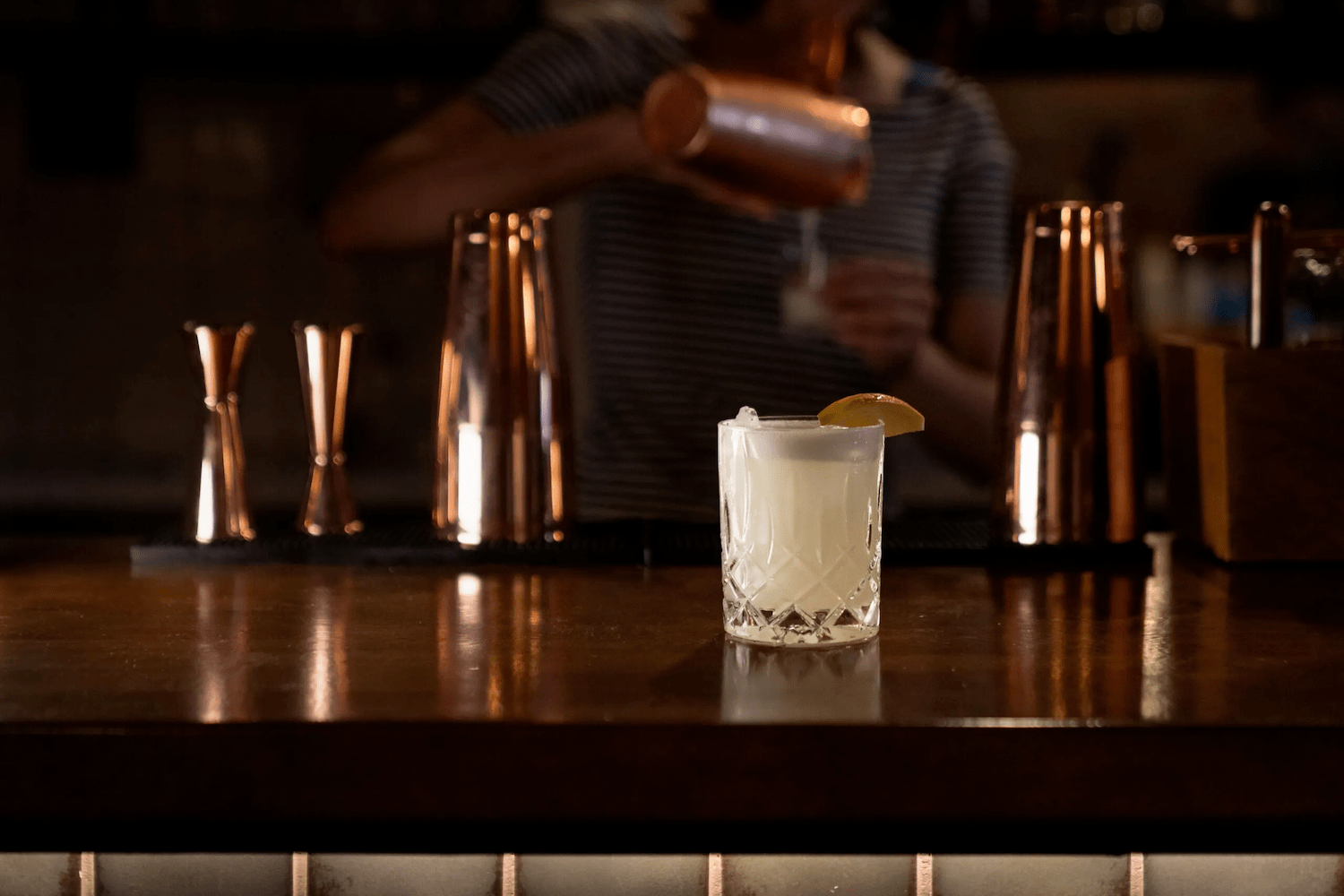 A cocktail on a brown bar