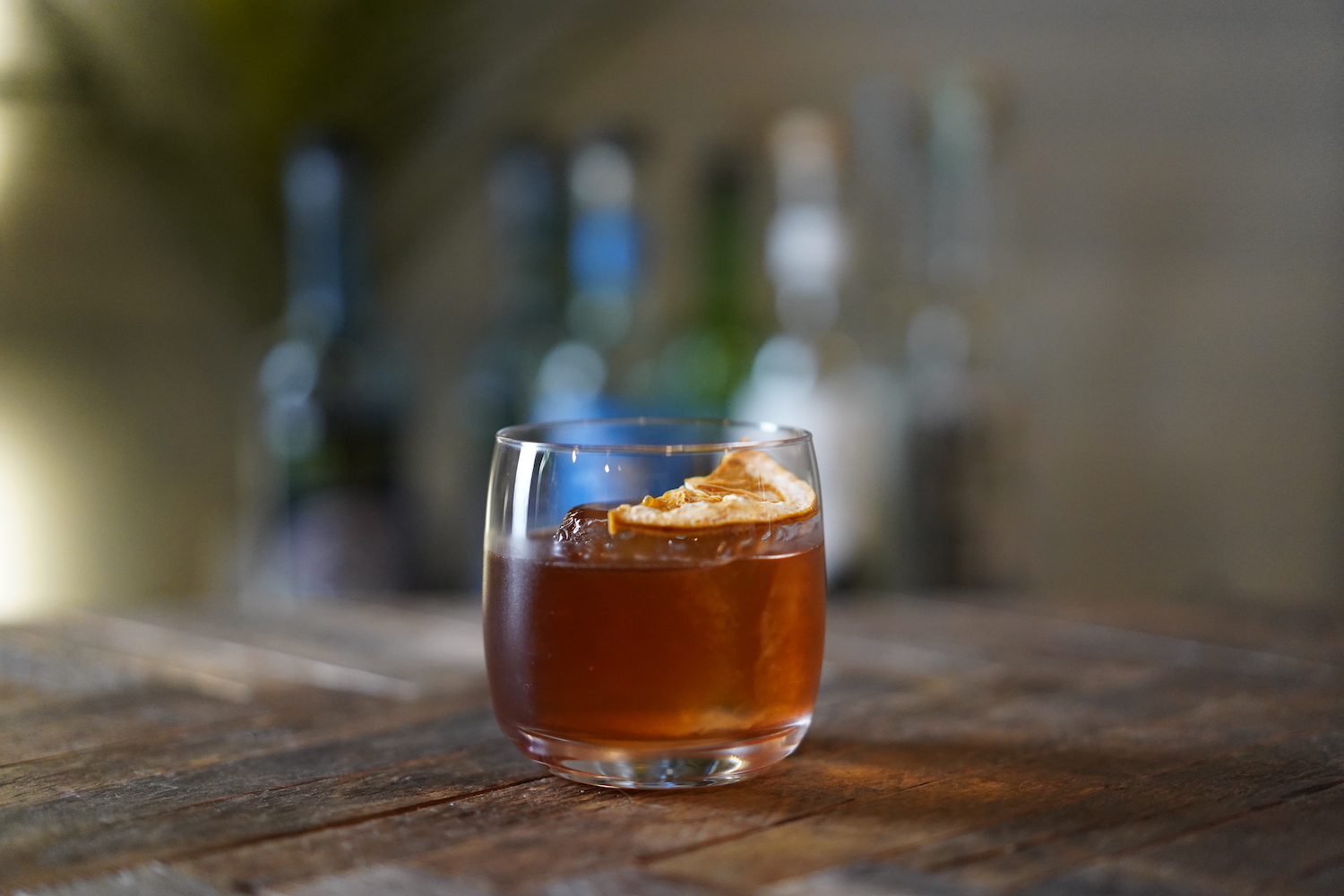 Tequila Old Fashioned sitting on a wooden table