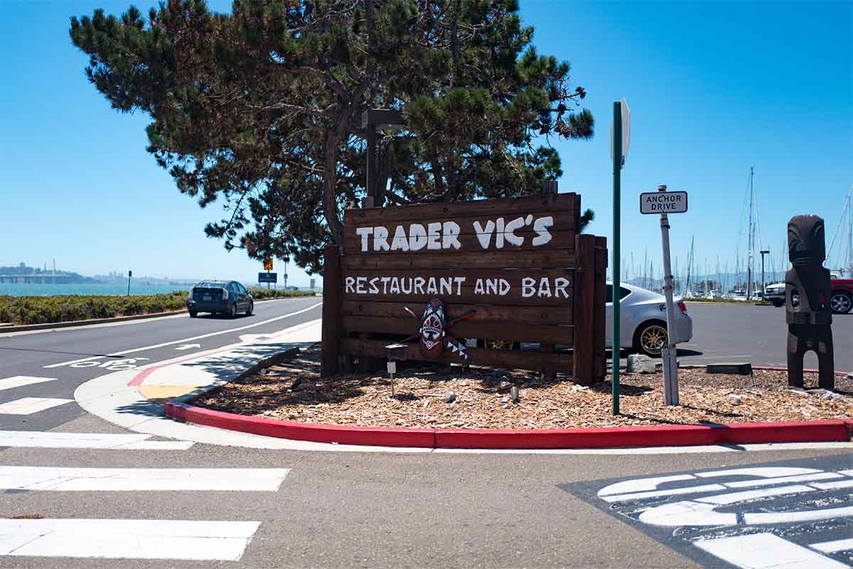 Sign with logo at entrance to the classic Trader Vic's restaurant, often credited as the inventor of the Mai Tai cocktail and originator of the Tiki Bar restaurant movement, Emeryville, California, July 10, 2018.