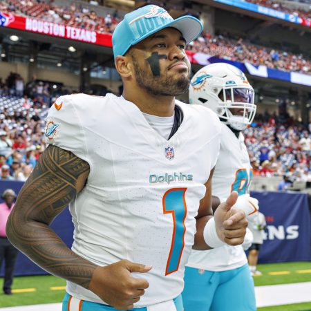 Tua Tagovailoa of the Dolphins jogs onto the field.