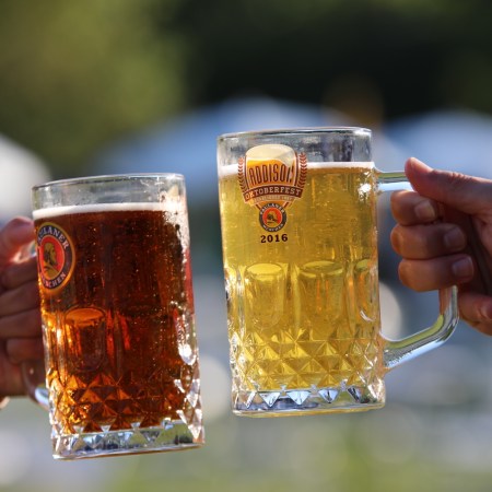 Two mugs of beer clinking