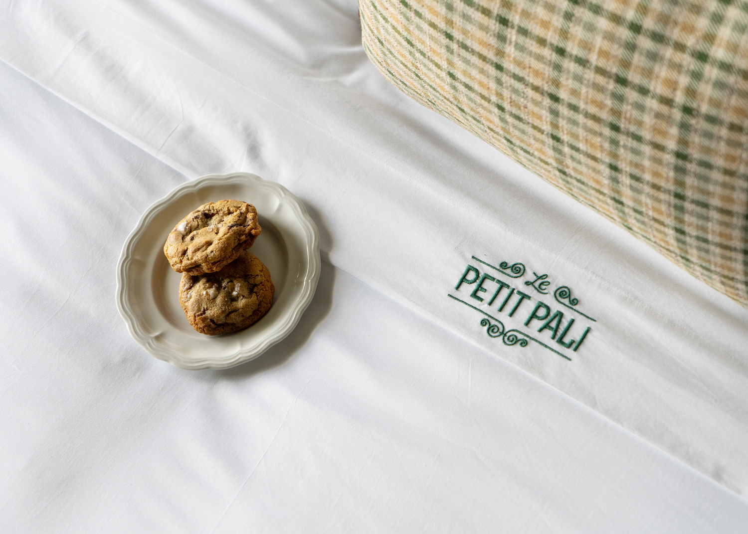 Chocolate chip cookies on a plate on the bed