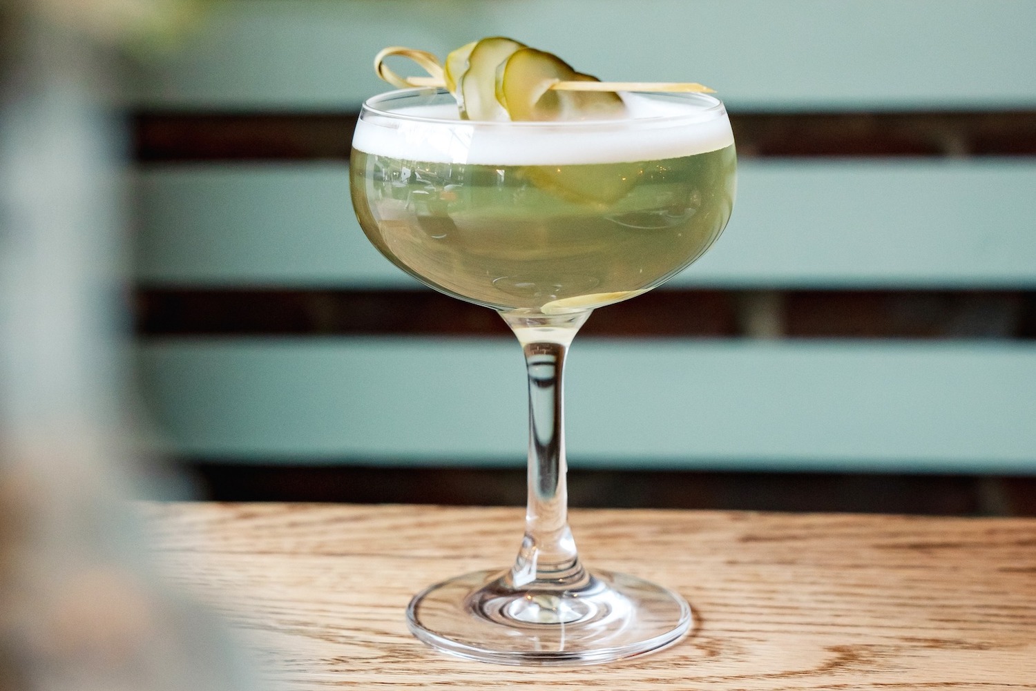 dirty pickle martini on a wooden table