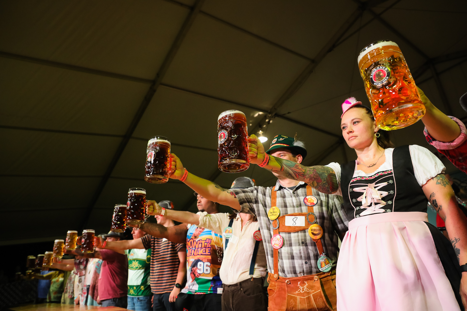 Group of people dressed up competing in a straight-arm contest