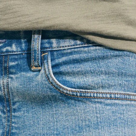 a close up of a model in Faherty's Organic Cotton Denim