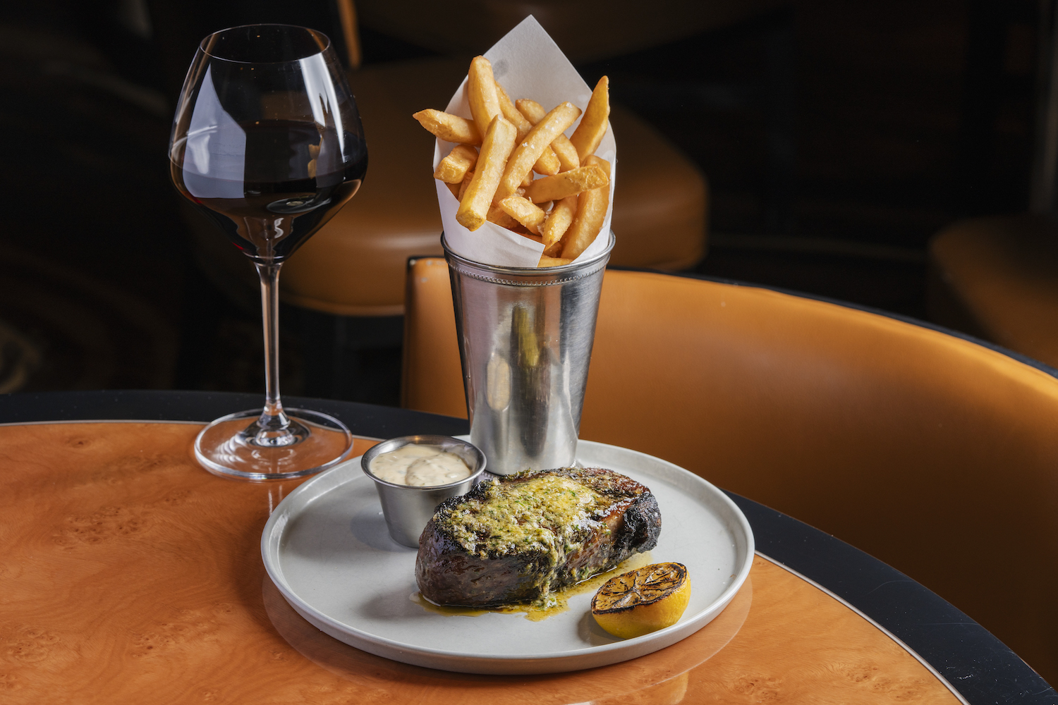 Steak, fries and a wine glass