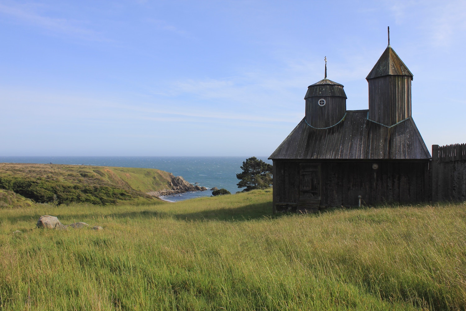 Small wood building overlooking hills and water