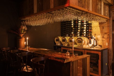 Dim bar area with glasses and bottles