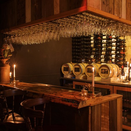 Dim bar area with glasses and bottles