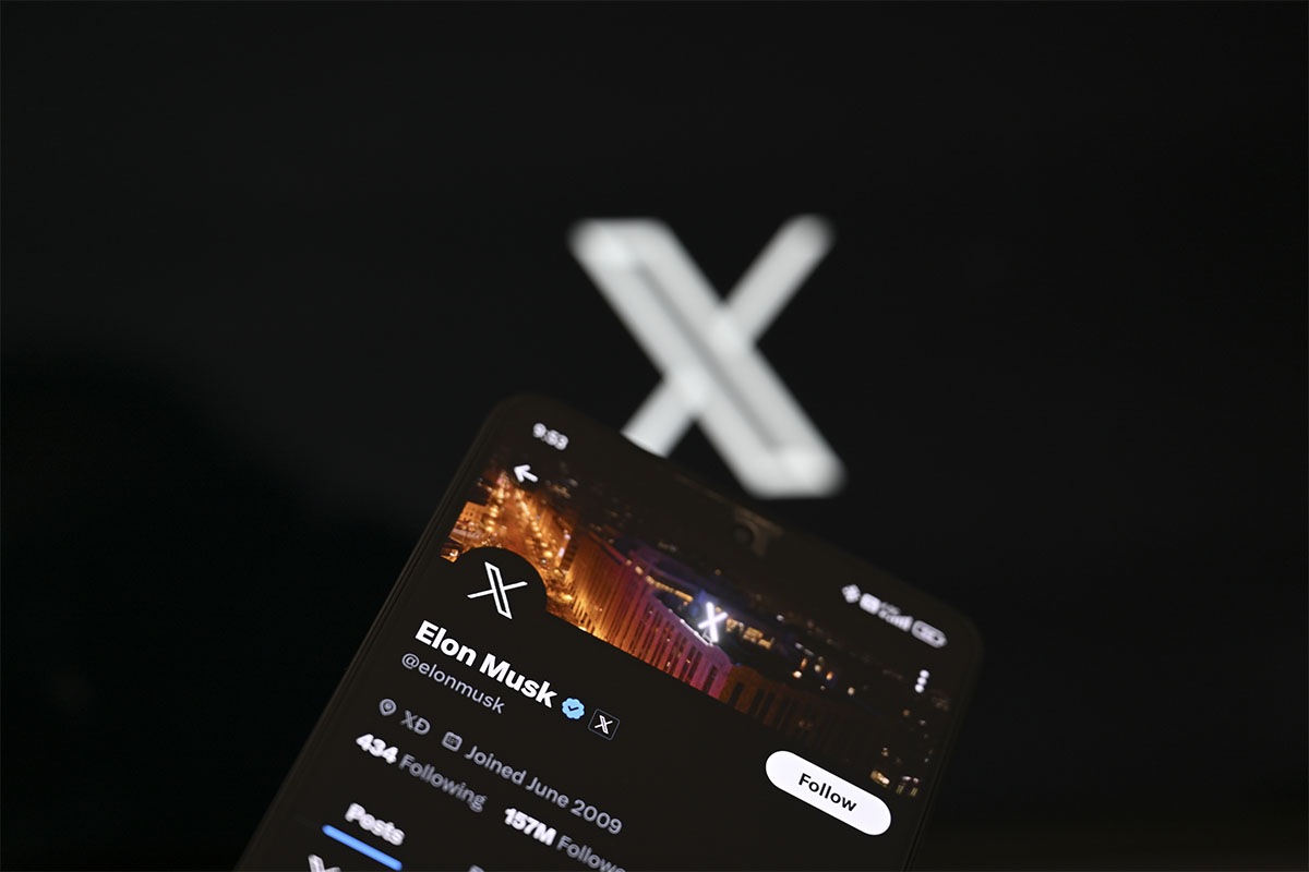 In this photo illustration, 'X' (formerly known as Twitter) Premium account of Elon Musk is displayed on a mobile phone screen in front of a computer screen displaying 'X' logo, in Ankara, Turkiye on September 19, 2023